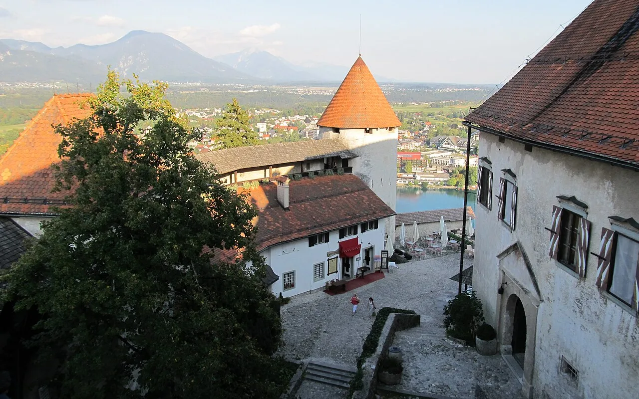 Looking out from the upper courtyard of Bled Castle over the roofs of Bled to the Alps